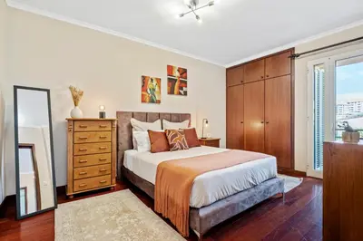 a bedroom with a bed and a dresser and a mirror at Our Nest by ALMA Holiday Rentals in Caniço