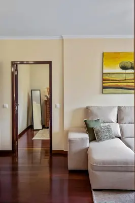 a living room with a couch and a mirror at Our Nest by ALMA Holiday Rentals in Caniço