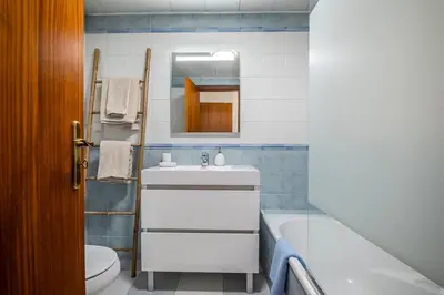 a bathroom with a sink and a tub and a toilet at Nata7 Apartment in Funchal