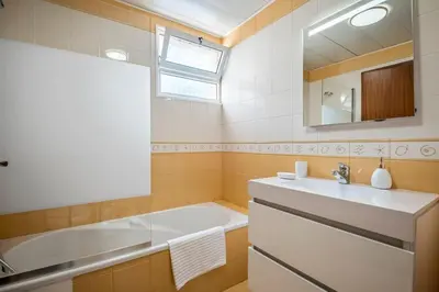 a bathroom with a sink and a bath tub at Nata7 Apartment in Funchal