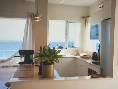 a kitchen with a potted plant sitting on a counter at Sunny seaside stay in Vila Baleira