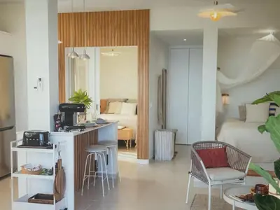 a living room with a kitchen and a bedroom at Sunny seaside stay in Vila Baleira