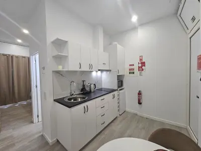 a kitchen with white cabinets and a sink at Faty`s Place by Susys Holidays in Santa Cruz