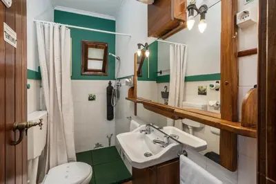 a bathroom with a sink and a mirror at Antiga Fábrica da Manteiga by An Island Apart in Arco da Calheta