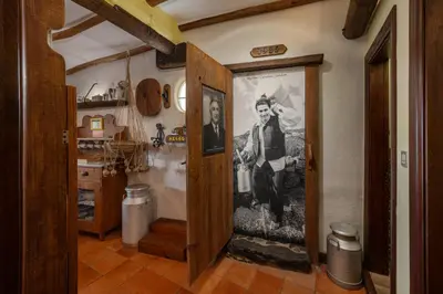 a hallway with a door with a picture on the wall at Antiga Fábrica da Manteiga by An Island Apart in Arco da Calheta