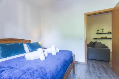 a bedroom with a large bed and a window at Avo Maria House by AH in São Vicente