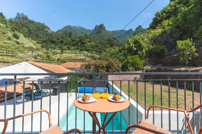 a balcony with a table and chairs and a view at Avo Maria 2 House by AH in São Vicente