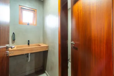 a bathroom with a wooden sink and a window at Vilaugusto in São Vicente