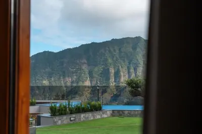a view of a mountain from a window at Vilaugusto in São Vicente