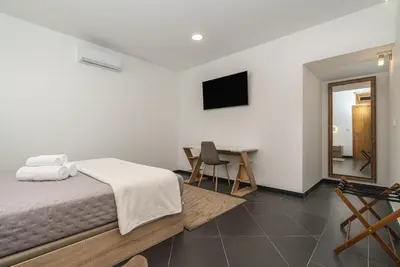 a bedroom with a bed with two towels on it at Rodrigues House - Private Jacuzzi in Calheta