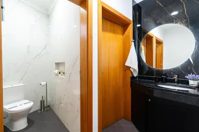 a large kitchen with a stainless steel refrigerator at Rodrigues House - Private Jacuzzi in Calheta