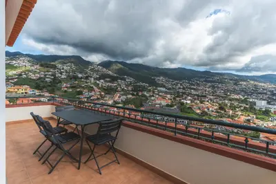 a table and chairs on a balcony with a view at Santo Antonio View by Atlantic Holiday in Funchal