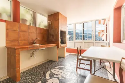 a kitchen with a sink and a table and chairs at Santo Antonio View by Atlantic Holiday in Funchal