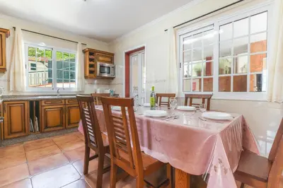 a kitchen with a table with a pink table cloth on it at Santo Antonio View by Atlantic Holiday in Funchal