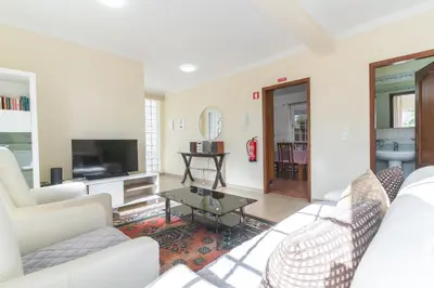 a living room with white furniture and a flat screen tv at Santo Antonio View by Atlantic Holiday in Funchal