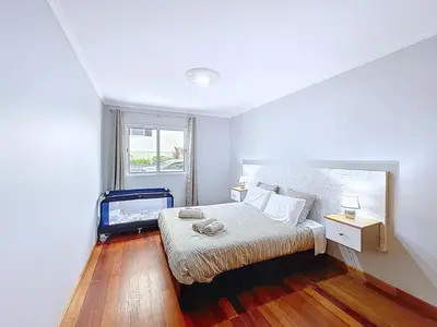 a bedroom with a bed and a window at Apartamento Bela Vista in Calheta