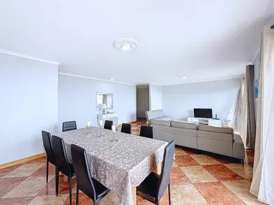 a dining room with a table and a couch at Apartamento Bela Vista in Calheta