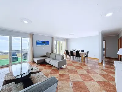 a living room with a couch and a table at Apartamento Bela Vista in Calheta