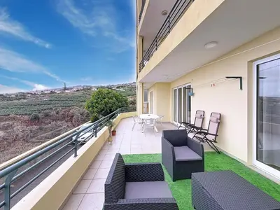 a balcony with a table and chairs and a view at Apartamento Bela Vista in Calheta