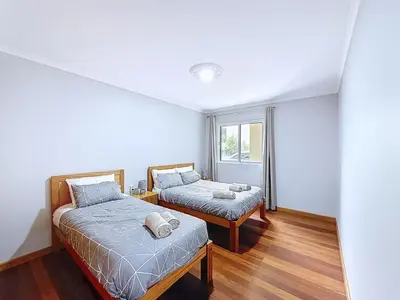 a bedroom with two beds and a window at Apartamento Bela Vista in Calheta