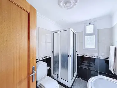a bathroom with a toilet and a shower at Apartamento Bela Vista in Calheta