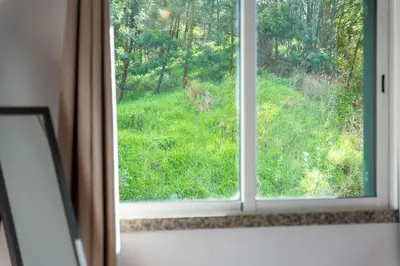 a window with a view of a field of grass at Brisa do Caniço in Caniço