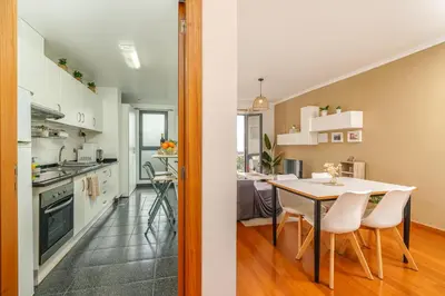 a kitchen and dining room with a table and chairs at Chill'Inn Madeira in Santa Cruz