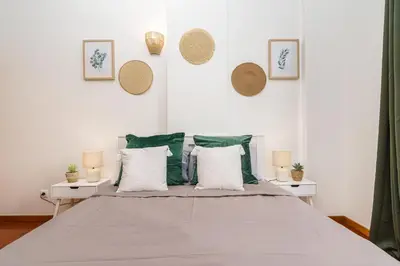 a bedroom with a large bed with white walls at Chill'Inn Madeira in Santa Cruz
