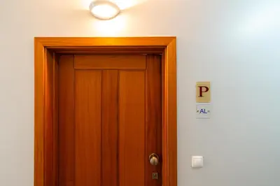 a wooden door with a light on top of it at Chill'Inn Madeira in Santa Cruz