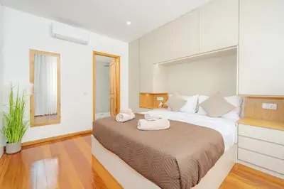 a bedroom with a large bed with towels on it at JPL - Preces Residential in Câmara de Lobos