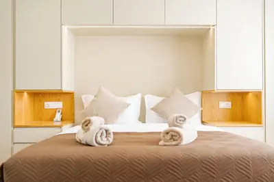 a bedroom with a large bed with towels on it at JPL - Preces Residential in Câmara de Lobos