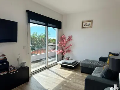 a living room with a couch and a large window at Casa de Ferias dos Marmeleiros in Funchal
