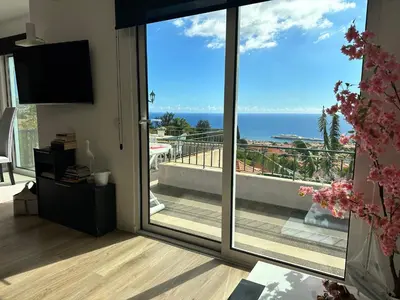 a living room with a view of the ocean at Casa de Ferias dos Marmeleiros in Funchal