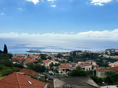 a view of a city with the ocean in the background at Casa de Ferias dos Marmeleiros in Funchal