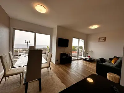 a living room with a dining room table and a couch at Casa de Ferias dos Marmeleiros in Funchal