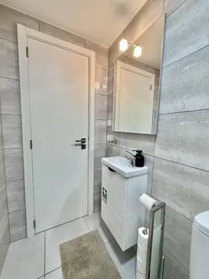 a kitchen with a table and a washing machine at Atlantic Harmony Residence in Funchal