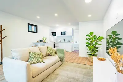 a living room with a couch and a kitchen at Nobregas Lodge in Senhora do Rosário