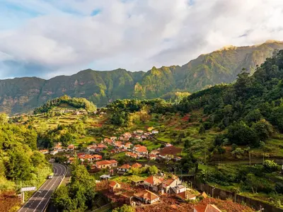 a town in the mountains with a road at Nobregas Lodge in Senhora do Rosário
