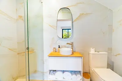 a bathroom with a shower and a sink and a mirror at Nobregas Lodge in Senhora do Rosário