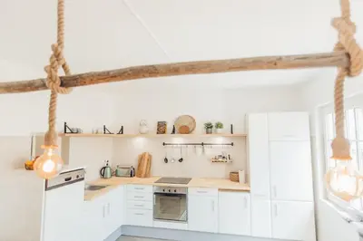 a kitchen with white cabinets and white appliances at Sunset Hideaway - a private paradies in Aljezur
