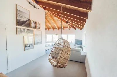 a room with a rattan swing hanging from the ceiling at Sunset Hideaway - a private paradies in Aljezur