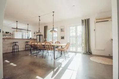 a kitchen and dining room with a table and chairs at Sunset Hideaway - a private paradies in Aljezur
