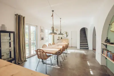 a dining room with a long table and chairs at Sunset Hideaway - a private paradies in Aljezur