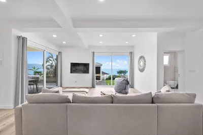 a living room with a couch and a tv at Loft - Villa Casa do mar in Ponta Delgada