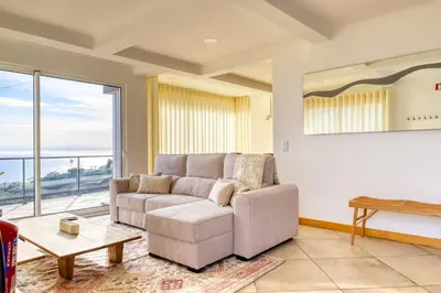 a living room with a couch and a table at Ponta do Sol Sea View, a Home in Madeira in Ponta do Sol