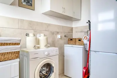 a small laundry room with a washer and dryer at Ponta do Sol Sea View, a Home in Madeira in Ponta do Sol