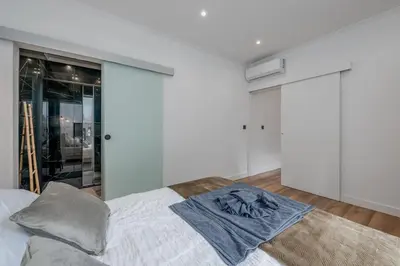 a bedroom with a bed with a white wall at Stylish 1 Bed Room in Funchal