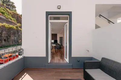 a view from the balcony of a house with a living room at Stylish 1 Bed Room in Funchal
