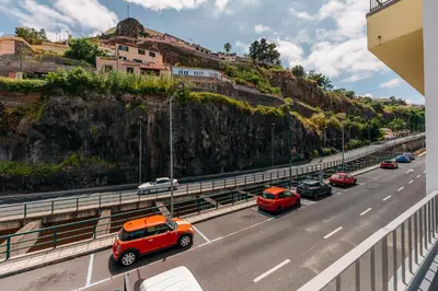 a highway with cars parked on the side of a mountain at Stylish 1 Bed Room in Funchal