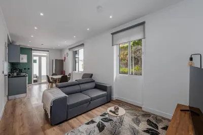 a living room with a couch and a table at Stylish 1 Bed Room in Funchal